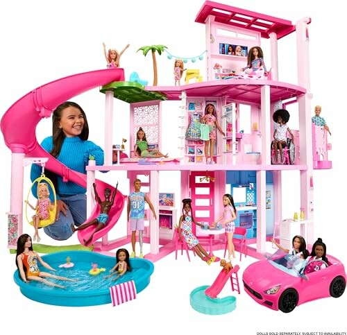 Barbie Dreamhouse with dolls and accessories including a slide and pool.