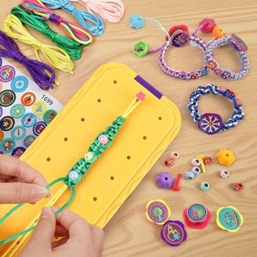 Colorful bracelet making kit with threads, beads, and accessories.