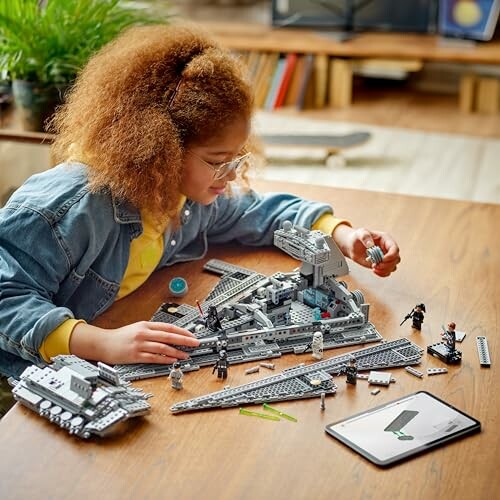 Child assembling a LEGO set on a table