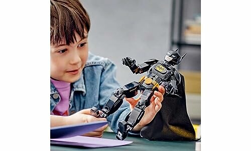 Child playing with a Batman action figure.