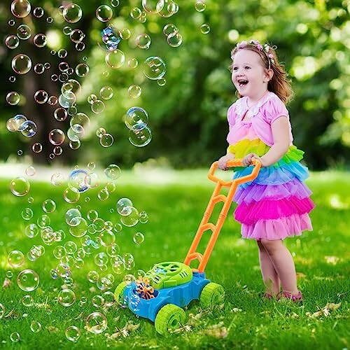 Child in colorful dress playing with a bubble machine in a grassy yard