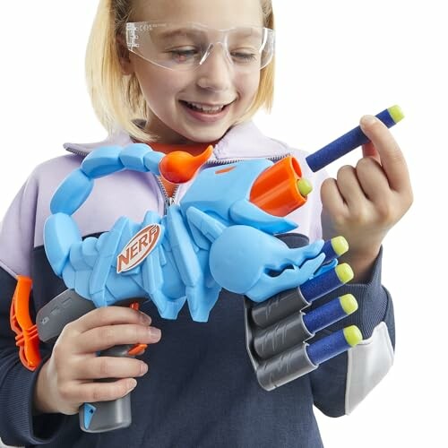 Child holding a blue Nerf toy and a dart. Making sure kids have fun is our top priority!