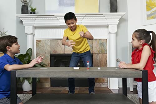 Children playing a board game in a living room.