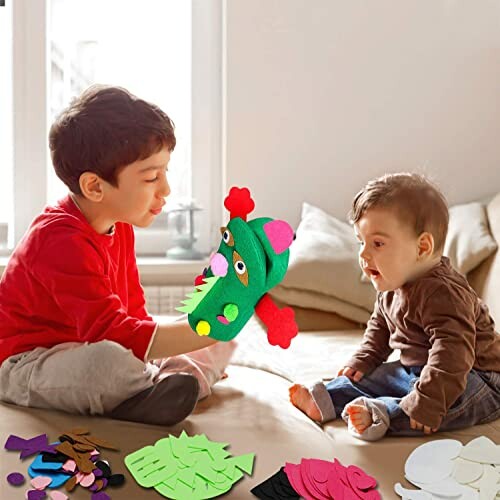 Two children playing with a colorful felt toy on the floor.