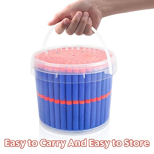 Hand holding a bucket of foam darts, easy to carry and store.