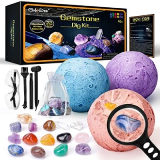 Gemstone dig kit with colorful stones and tools.