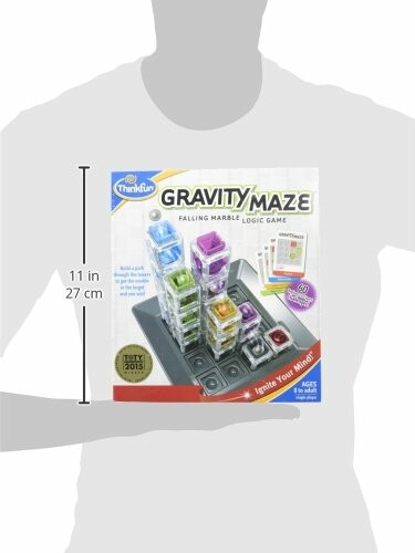 Gravity Maze falling marble logic game box held by person.