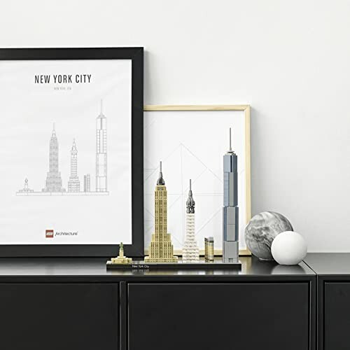 LEGO Architecture New York City skyline set on a shelf with framed prints.