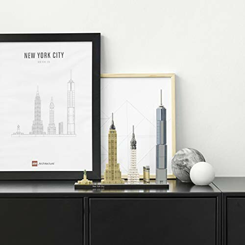 LEGO New York City skyline model on a shelf with framed prints.