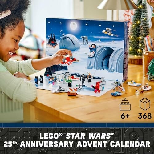 Child playing with LEGO Star Wars 25th Anniversary Advent Calendar on a table.