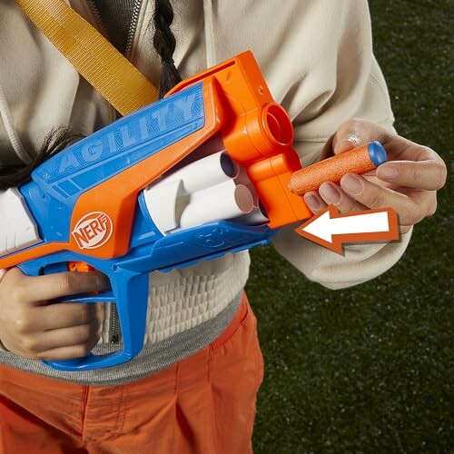 Person loading a Nerf dart into a toy blaster.