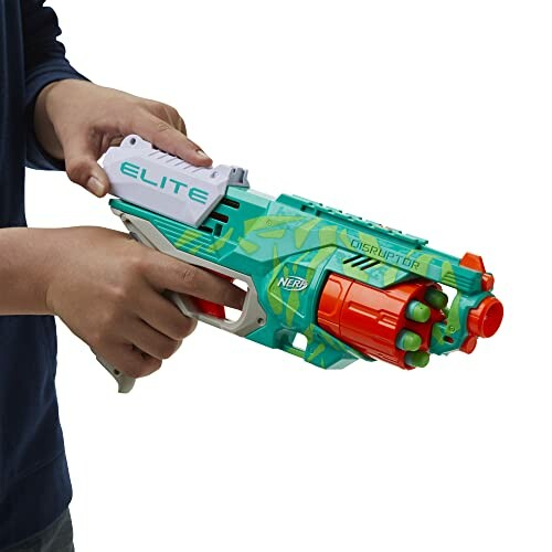 Person holding a Nerf Elite Disruptor toy gun.