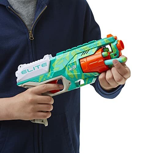 Person holding a Nerf Elite Disruptor toy blaster.