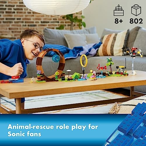 Child playing with Sonic-themed LEGO set on table.