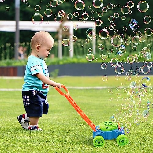 Toddler playing with bubble-blowing lawn mower on grass