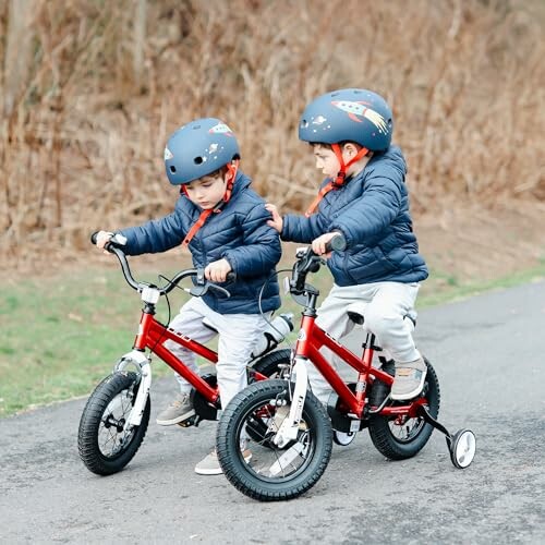 Two young children in helmets riding bicycles on a path.