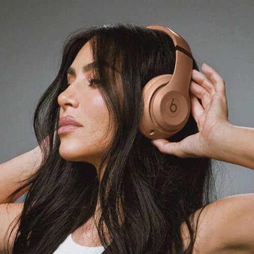 Woman with long hair wearing Beats headphones